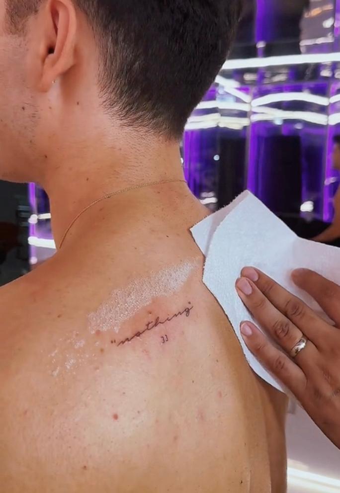 PHOTO: This still from a video shows Ezra Sosa getting Anna Delvey's last words on "Dancing With The Stars" tattooed on his back.