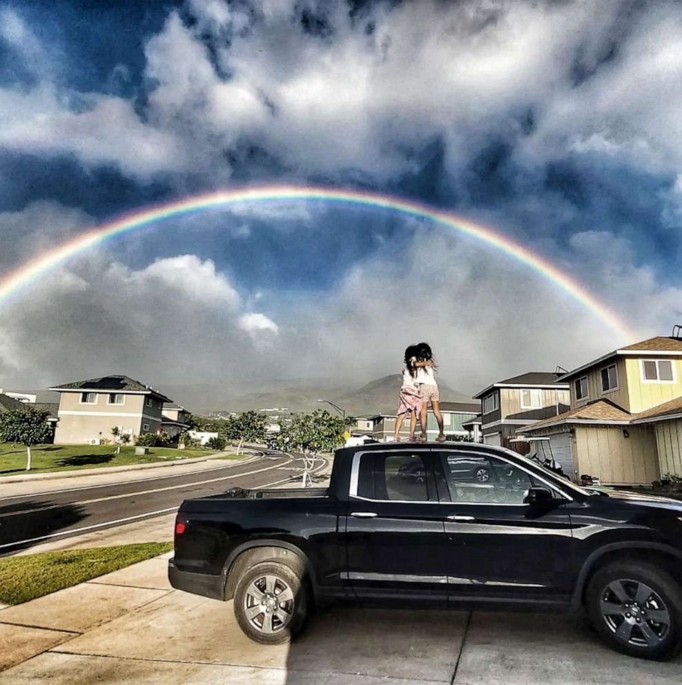 PHOTO: Aubrey Vailoces' twin daughters watch a rainbow over their neighborhood in Maui.