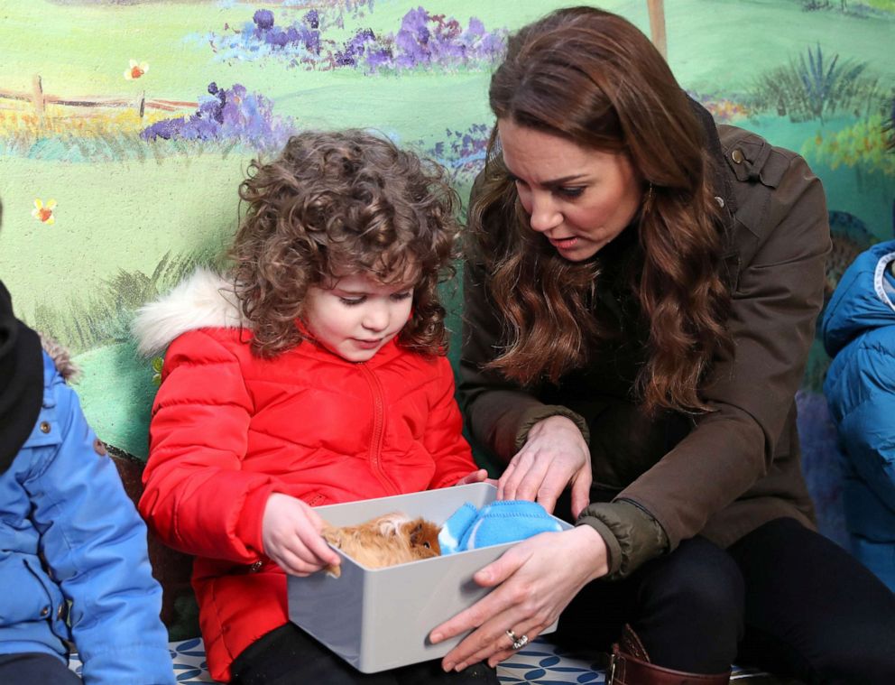 PHOTO: Britain's Catherine, Duchess of Cambridge, looks at a Guinea pig