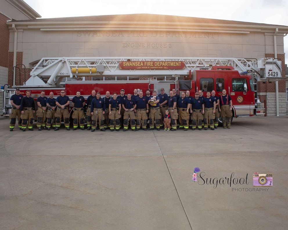 PHOTO: Baby Brett photographed with her late father's colleagues at the Swansea firehouse.