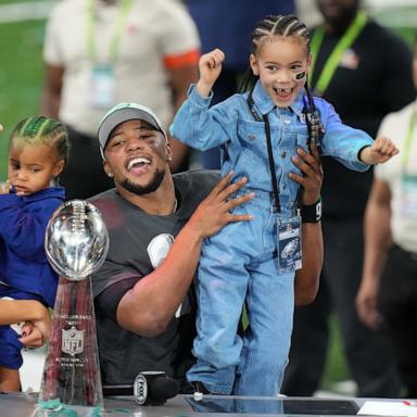 PHOTO: Philadelphia Eagles running back Saquon Barkley talks to the media with his daughter, Jada, after defeating the Kansas City Chiefs in Super Bowl LIX at Caesars Superdome on Feb 9, 2025 in New Orleans.