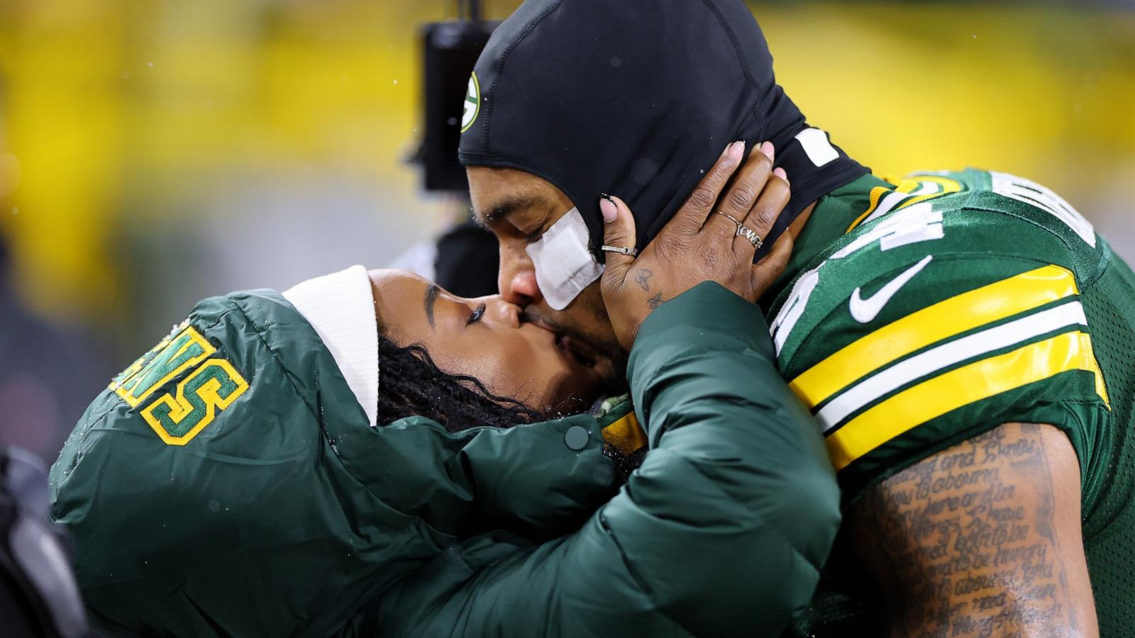 PHOTO: Olympic gold medalist Simone Biles kisses husband Jonathan Owens #34 of the Green Bay Packers before the game between the Kansas City Chiefs and the Green Bay Packers at Lambeau Field on Dec. 3, 2023 in Green Bay, Wisc.