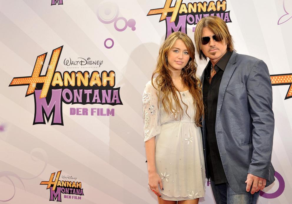 Miley Cyrus and her father Billy Ray Cyrus pose for photographers on the red carpet for the film "Hannah Montana - The Movie" on April 25, 2009.