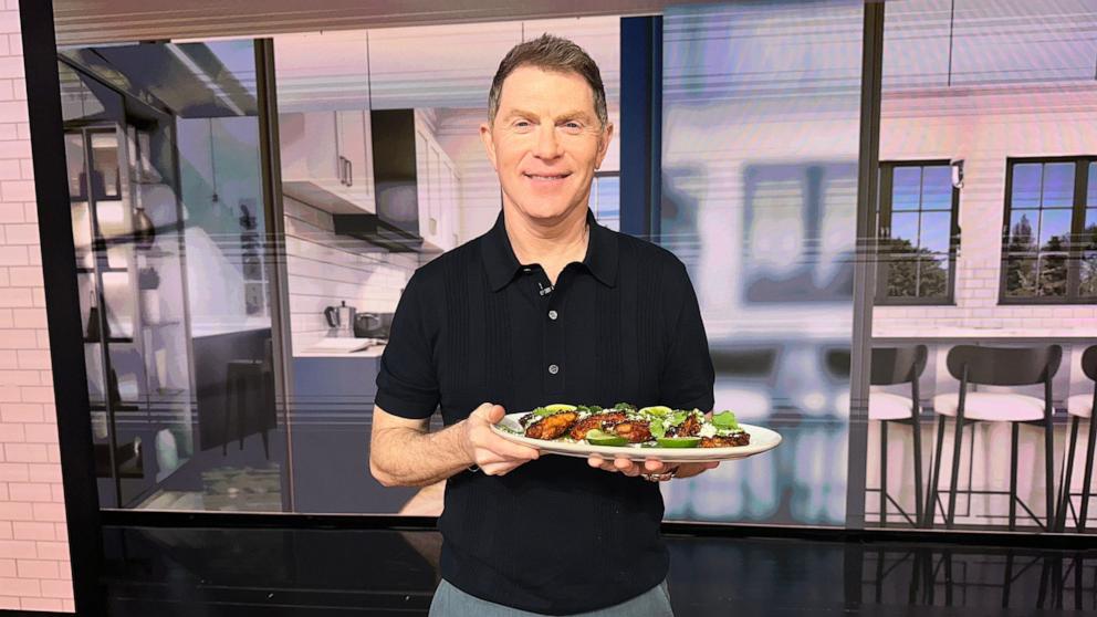 PHOTO: Chef Bobby Flay holds a tray of his grilled chicken thighs with aji verde.
