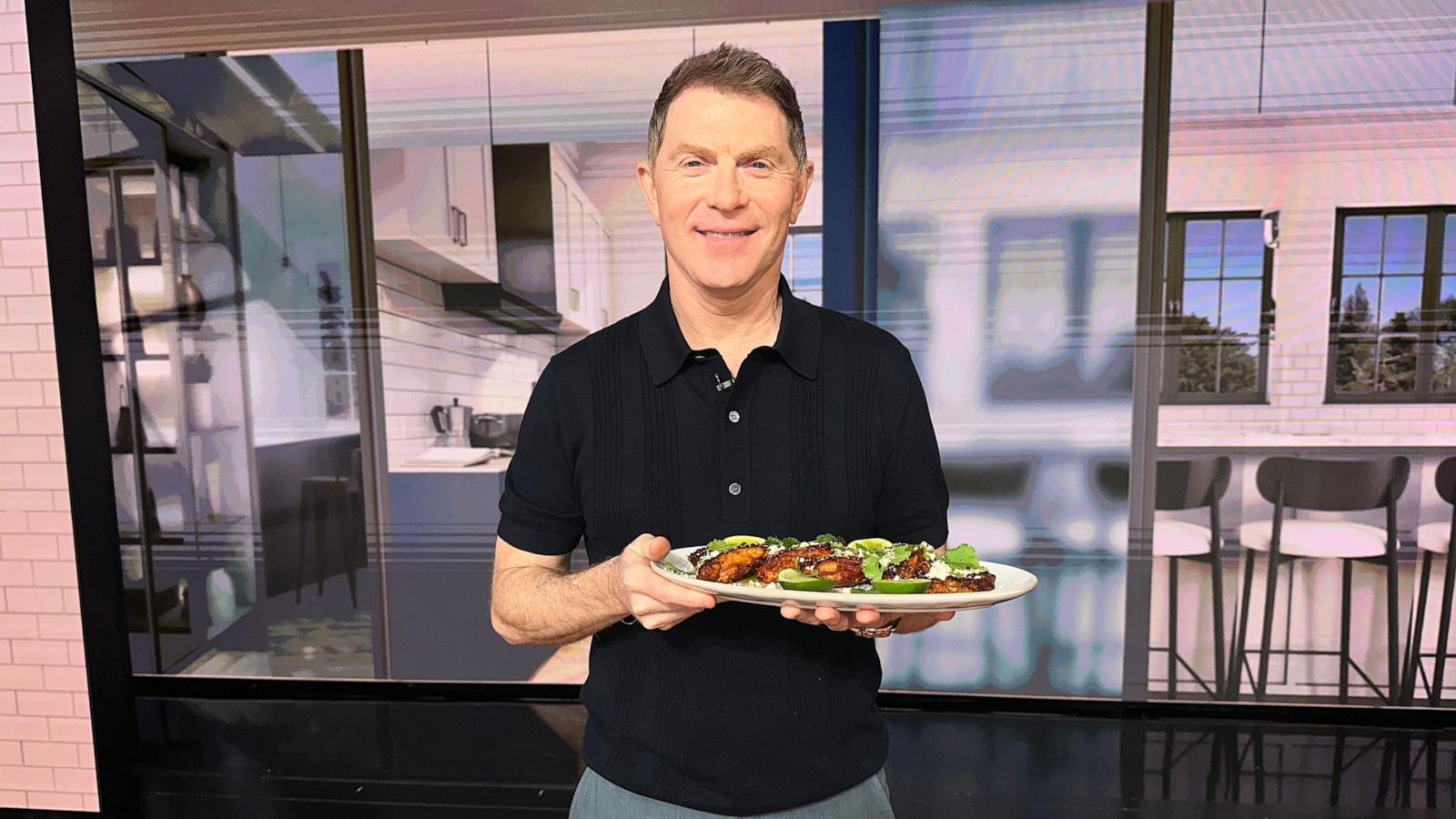 PHOTO: Chef Bobby Flay holds a tray of his grilled chicken thighs with aji verde.