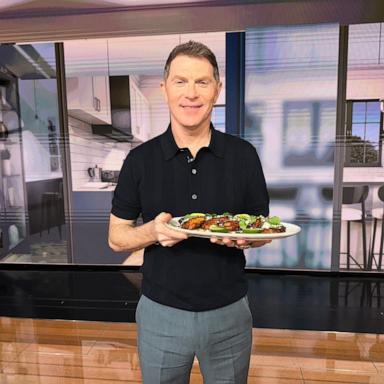 PHOTO: Chef Bobby Flay holds a tray of his grilled chicken thighs with aji verde.