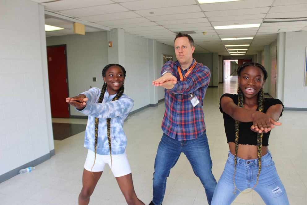 PHOTO: Dr. Trevor Boffone, a Spanish teacher at Bellaire High School in Bellaire, Texas, dances with his students, Takia and Talia Palmer.