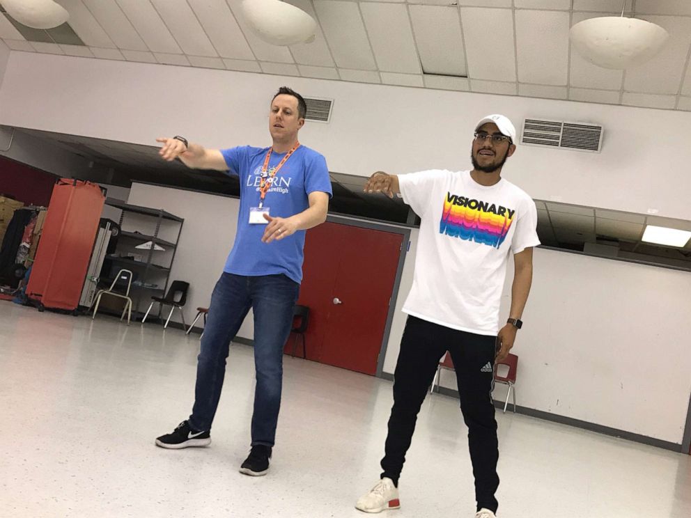 PHOTO: Dr. Trevor Boffone, a Spanish teacher at Bellaire High School in Bellaire, Texas, dances with Wilson Barrera.