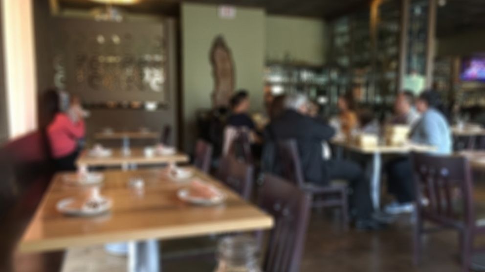 PHOTO: Brandy Ferner snapped this blurry photo in a restaurant to show the "unseen" work mothers do. 