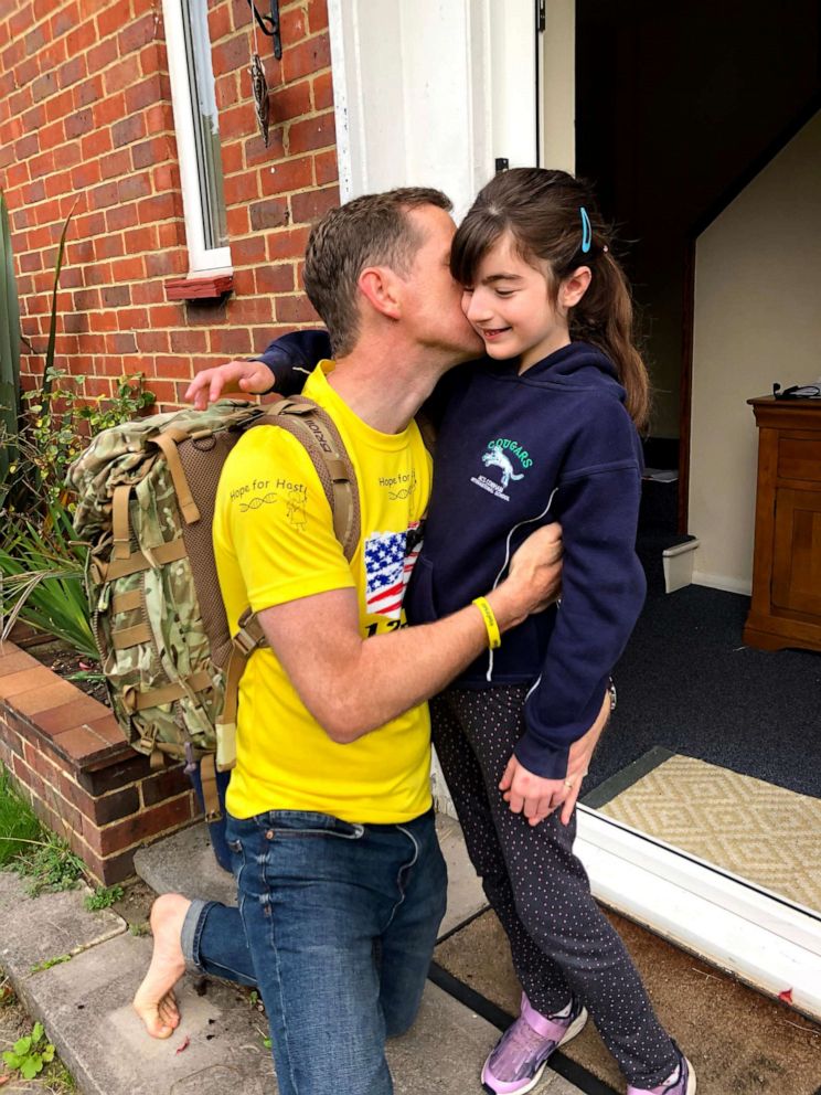 PHOTO: Chris Brannigan, 41, saying goodbye to Hasti, 9, before his barefoot walk in 2020.