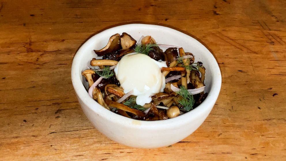 PHOTO: A bowl of mushroom bibimbap topped with poached egg.