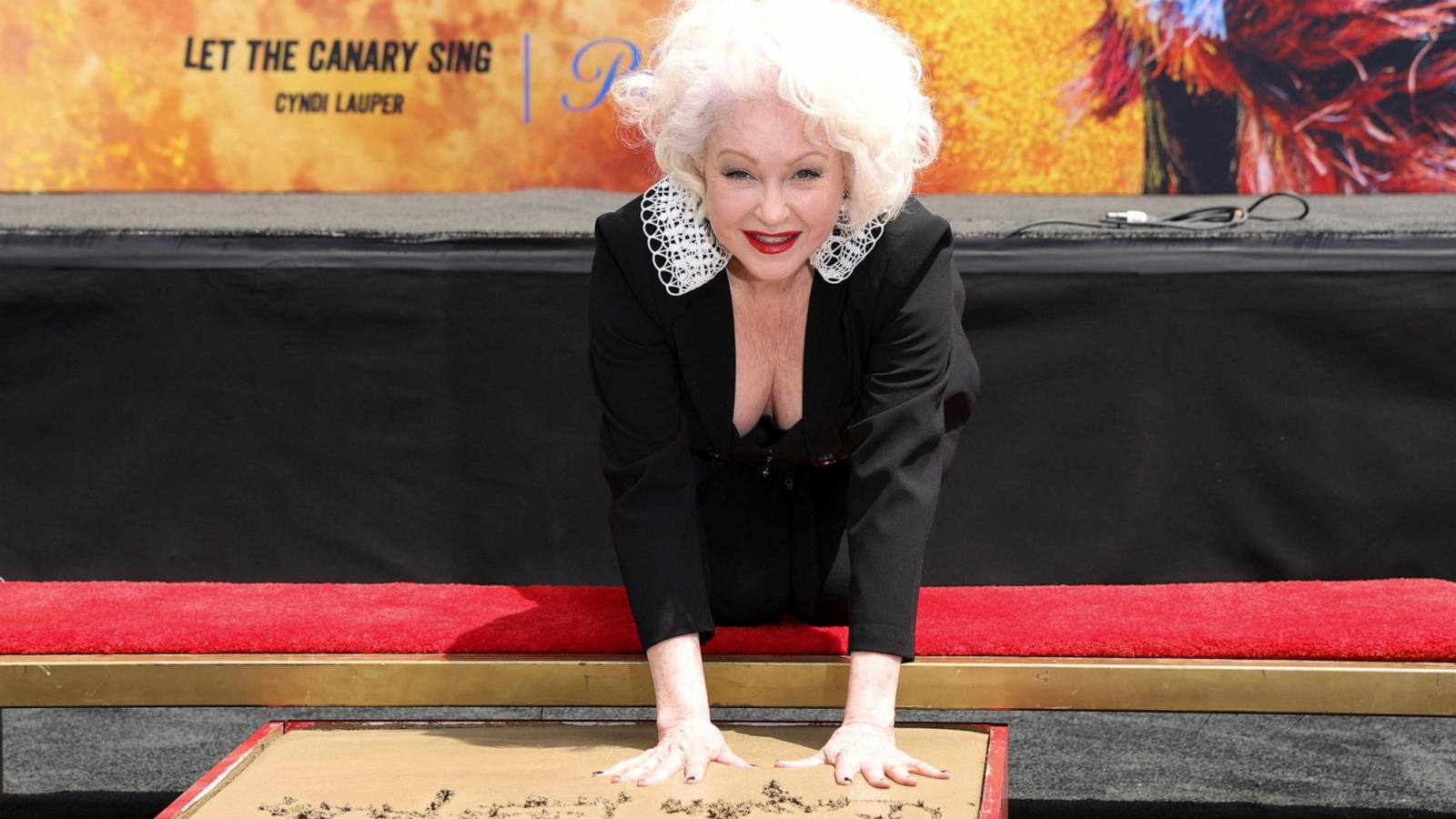 PHOTO: Cyndi Lauper places her handprints in cement during a ceremony at TCL Chinese Theatre in Los Angeles, June 4, 2024.