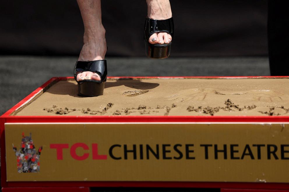 PHOTO: Cyndi Lauper places her footprints in cement at TCL Chinese Theatre in Los Angeles, June 4, 2024.