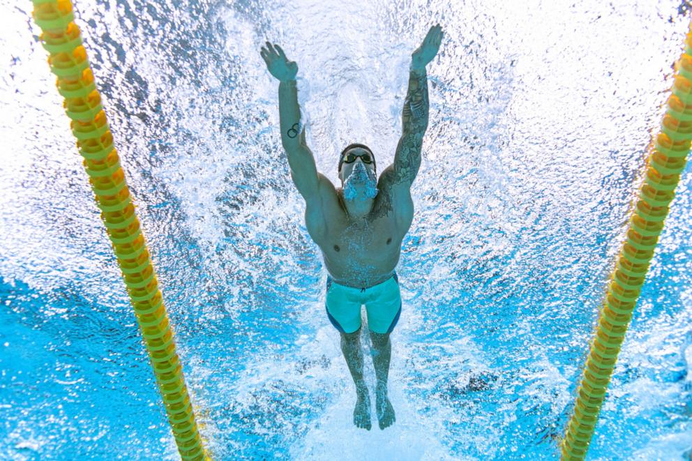 PHOTO: \=An underwater view shows USA's Caeleb Dressel competing in a semi-final of the men's 100m butterfly swimming event during the Tokyo 2020 Olympic Games at the Tokyo Aquatics Centre, July 30, 2021, in Tokyo.