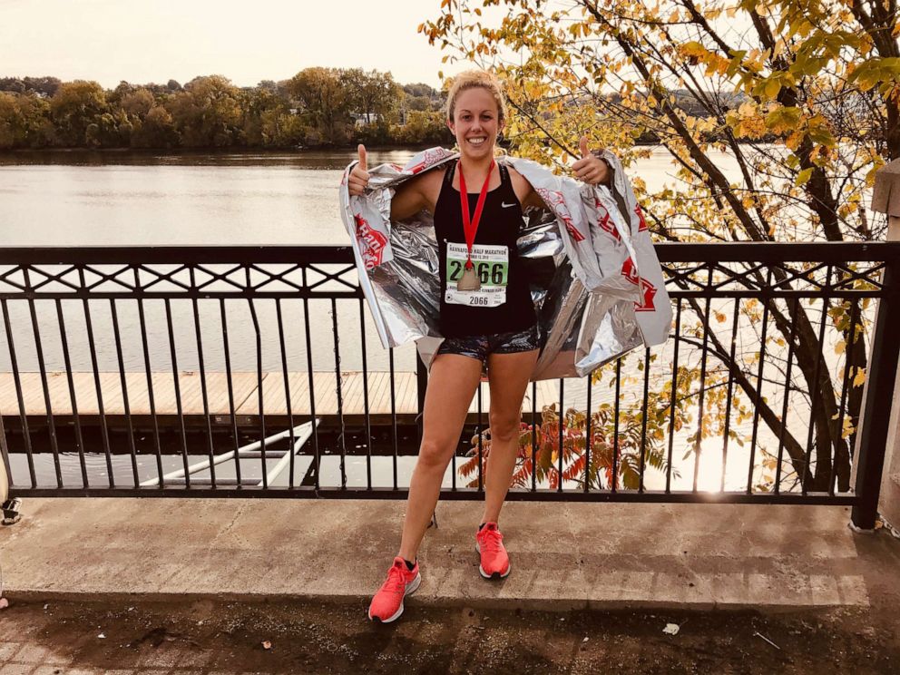 Caitlin Barber poses for a photo after a marathon. 