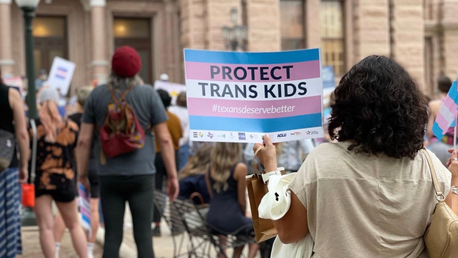 PHOTO: Camille Rey holds a sign that reads "Protect Trans Kids."