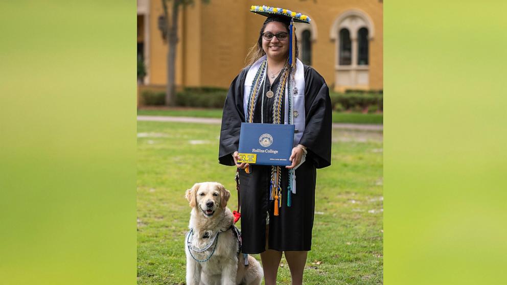 PHOTO: Cecilia Hernandez graduated from Rollins College on May 11 with a bachelor’s degree in chemistry alongside her service dog Canela.