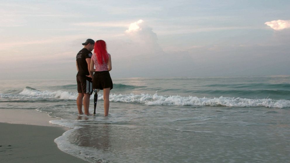 PHOTO: Paige Winter and her dad Charlie Winter stand on the beach where she was attacked by a shark one year earlier. 