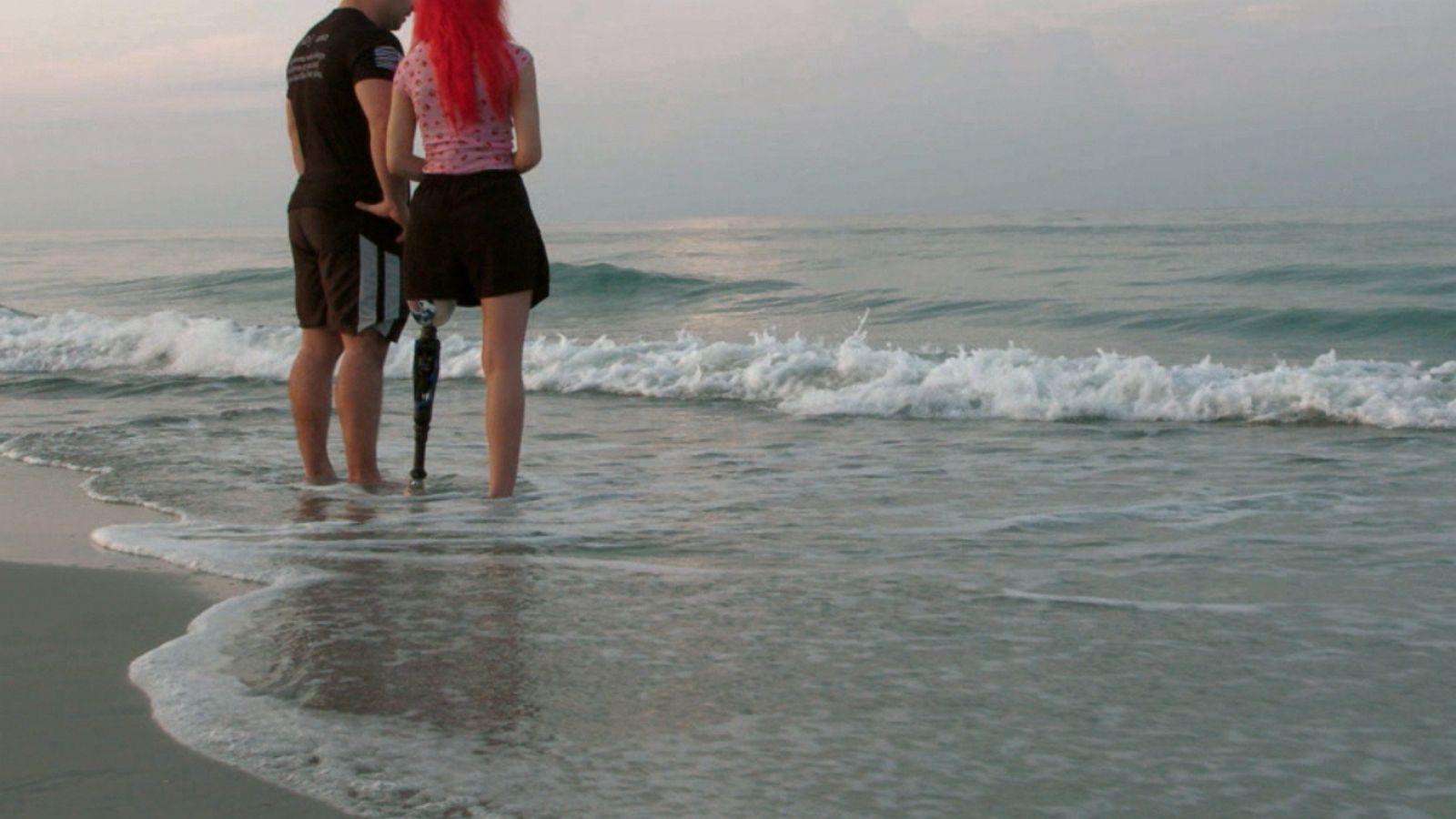 PHOTO: Paige Winter and her dad Charlie Winter stand on the beach where she was attacked by a shark one year earlier.