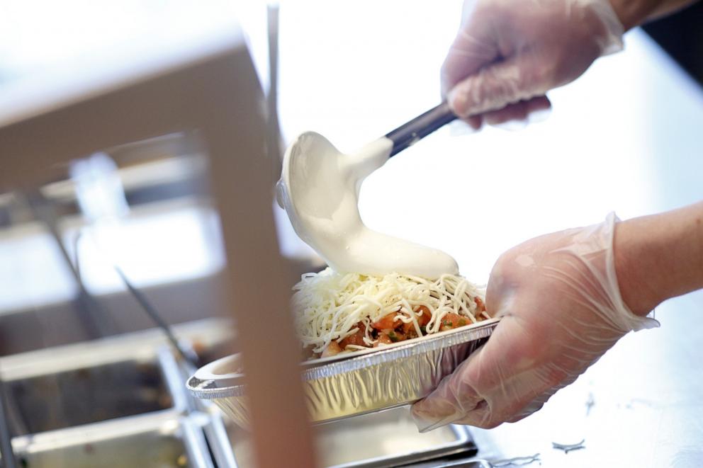 PHOTO: An employee adds sour cream to a burrito bowl at a Chipotle Mexican Grill Inc. restaurant in Louisville, Kentucky, Feb. 2, 2019. 