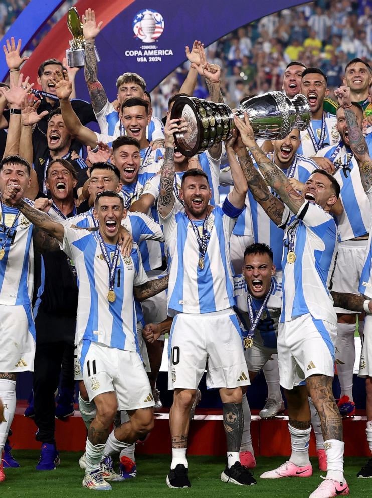 PHOTO: Argentina's Lionel Messi lifts the trophy as he celebrates with teammates after winning Copa America 2024 in Miami, FL, July 14, 2024.