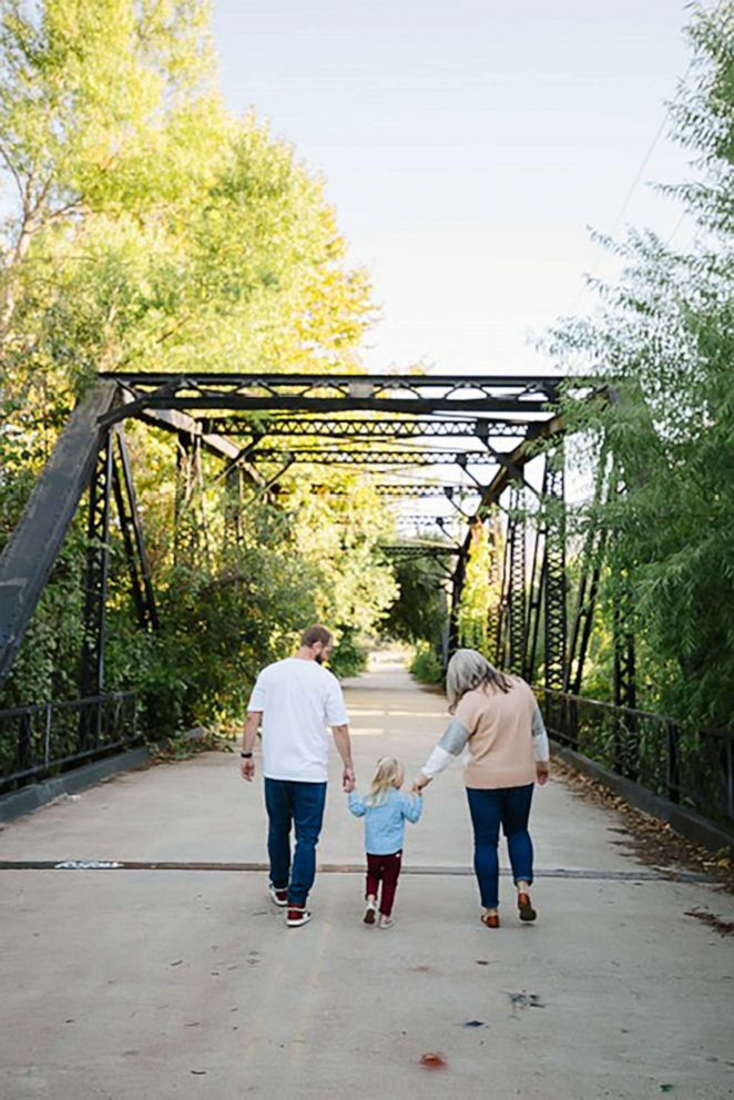 PHOTO: Amanda Courtney, of San Diego, walks with her husband and their 2-year-old daughter.