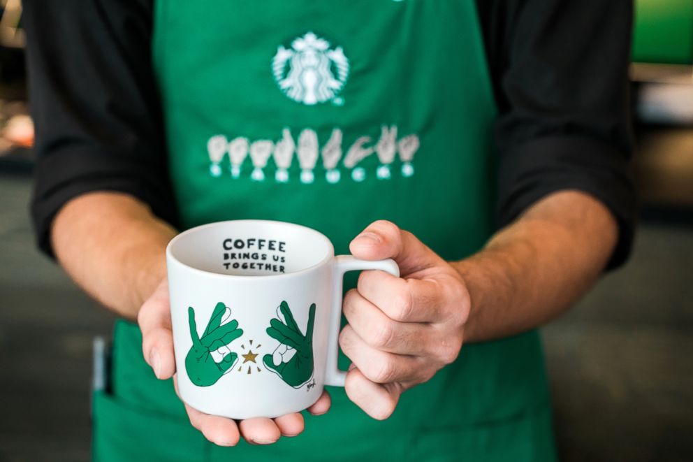 PHOTO: A partner holds a mug on Monday, October 22, 2018 at Starbucks first U.S. Signing Store in Washington D.C. 