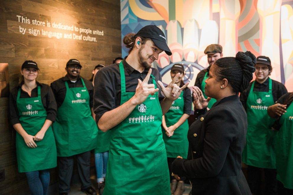 PHOTO: Starbucks District Manager Margaret Houston presents an apron to partner Glen Cole on Saturday, October 20, 2018 at Starbucks first U.S. Signing Store in Washington D.C.(Joshua Trujillo, Starbucks)