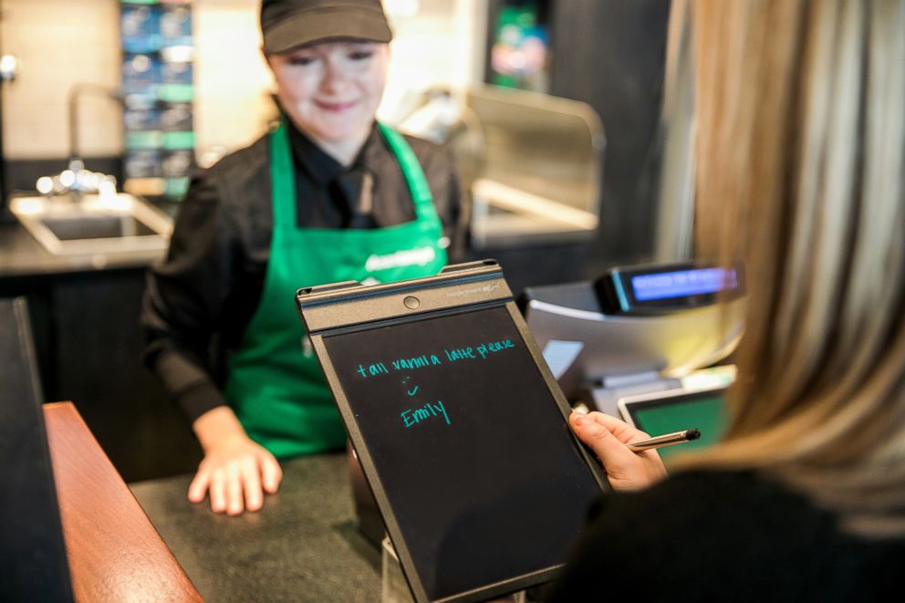 PHOTO: A customer takes an order on Monday, October 22, 2018 at Starbucks first U.S. Signing Store in Washington D.C.