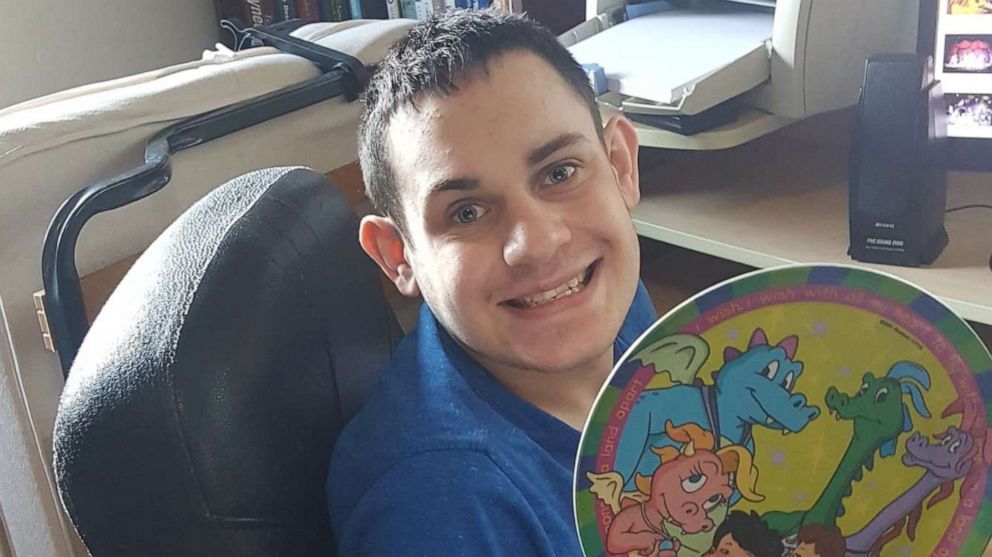 Daniel Dubin holds up his favorite plate, which features characters from the show "Dragon Tales."