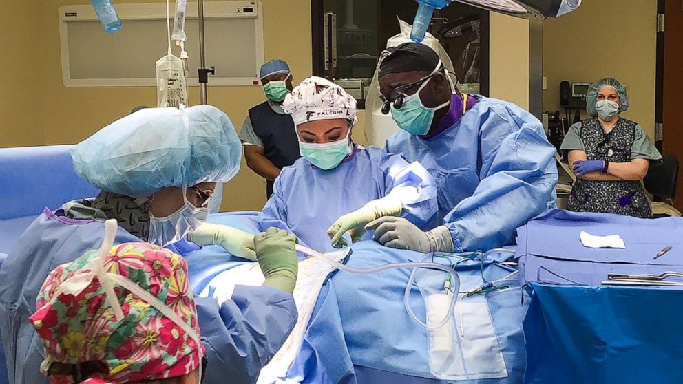 PHOTO: Neurosurgeon Dr. Dare Adewumi and his wife Dr. Susan Orillosa operate on a patient.