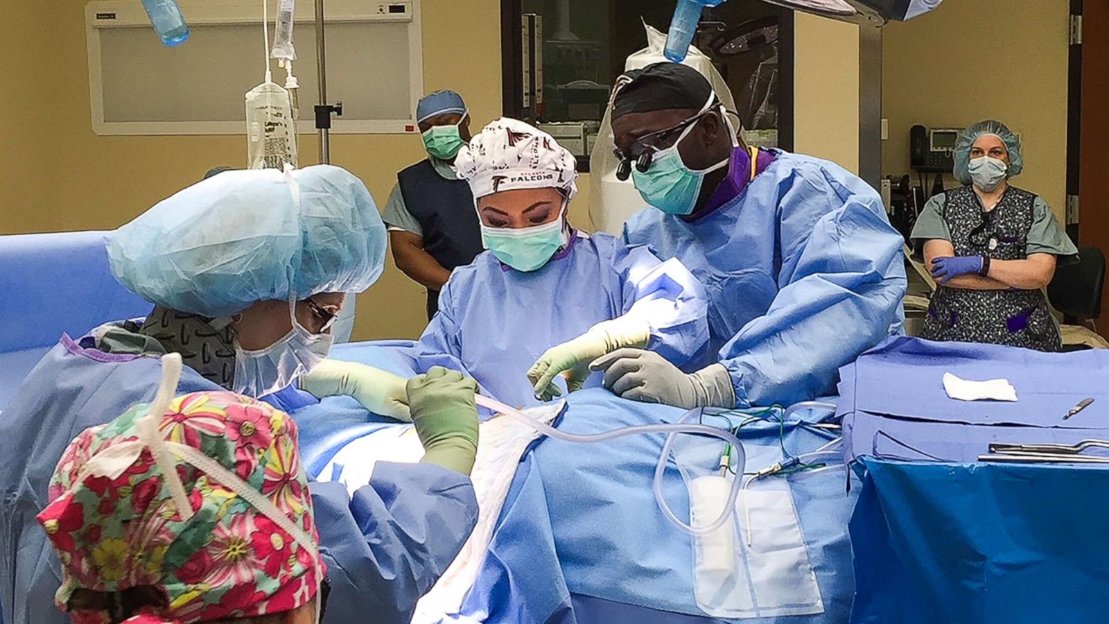 PHOTO: Neurosurgeon Dr. Dare Adewumi and his wife Dr. Susan Orillosa operate on a patient.