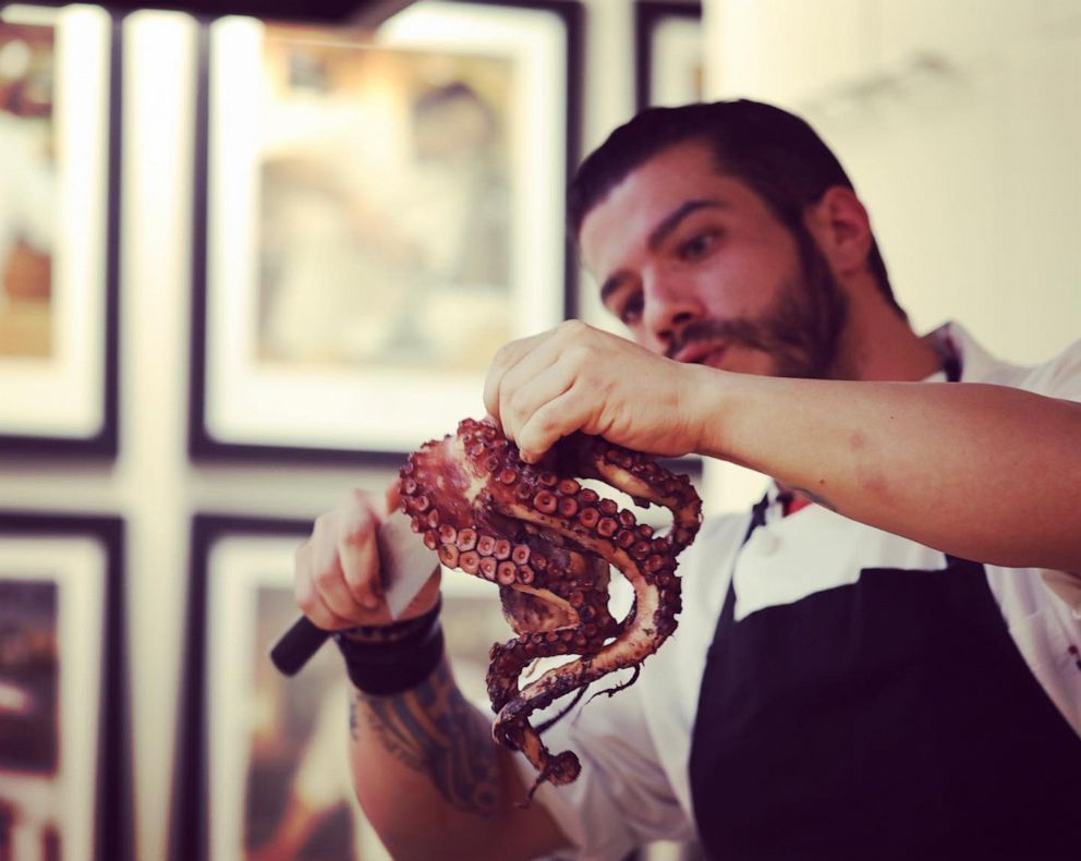 PHOTO: Chef Christos Bisiotis prepares octopus for a dish. 