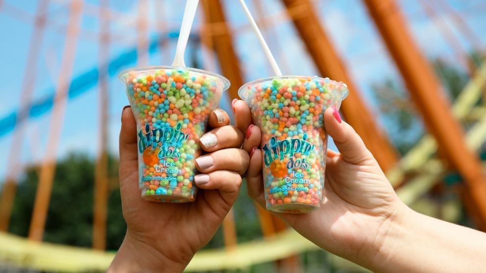 PHOTO: People hold up cups of Dippin' Dots.