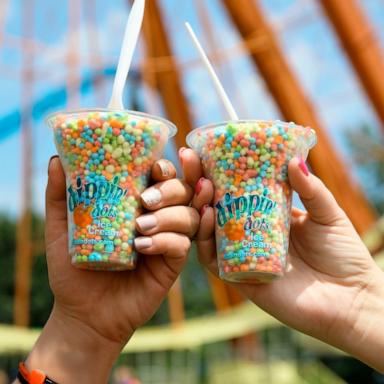 PHOTO: People hold up cups of Dippin' Dots.