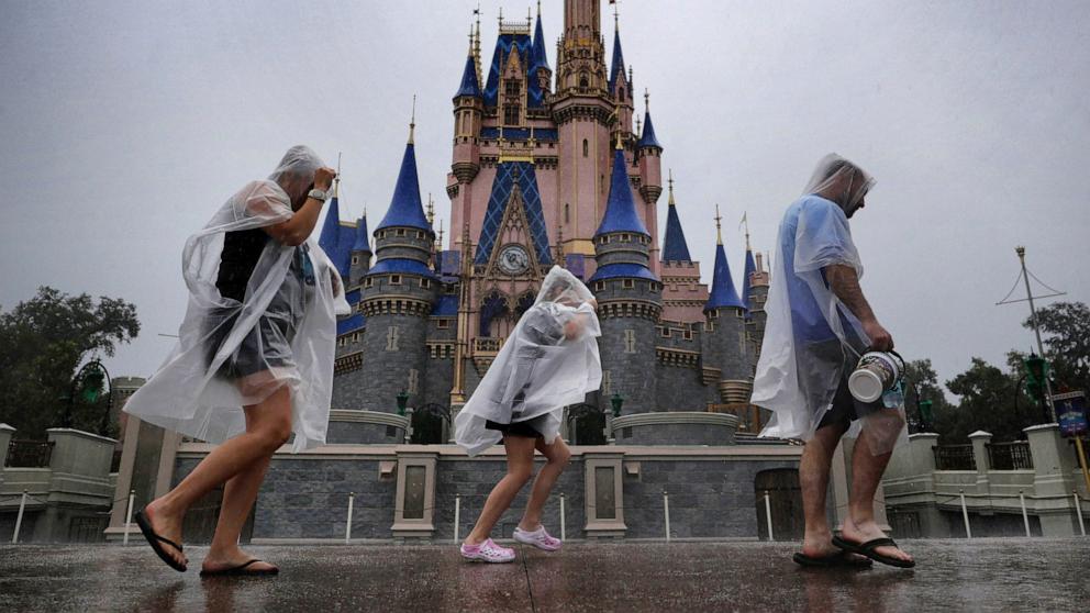 PHOTO: Guests weather early bands of rain from Hurricane Milton at the Magic Kingdom at Walt Disney World in Bay Lake, Fla., Oct. 9, 2024. 