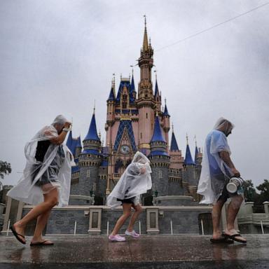 PHOTO: Guests weather early bands of rain from Hurricane Milton at the Magic Kingdom at Walt Disney World in Bay Lake, Fla., Oct. 9, 2024. 