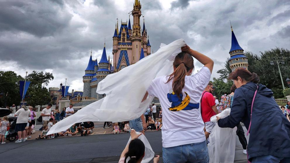 PHOTO: Guests at the Magic Kingdom break out ponchos at Cinderella Castle as bands of weather from Hurricane Helene move through Walt Disney World in Bay Lake, Fla., Sept. 26, 2024. 