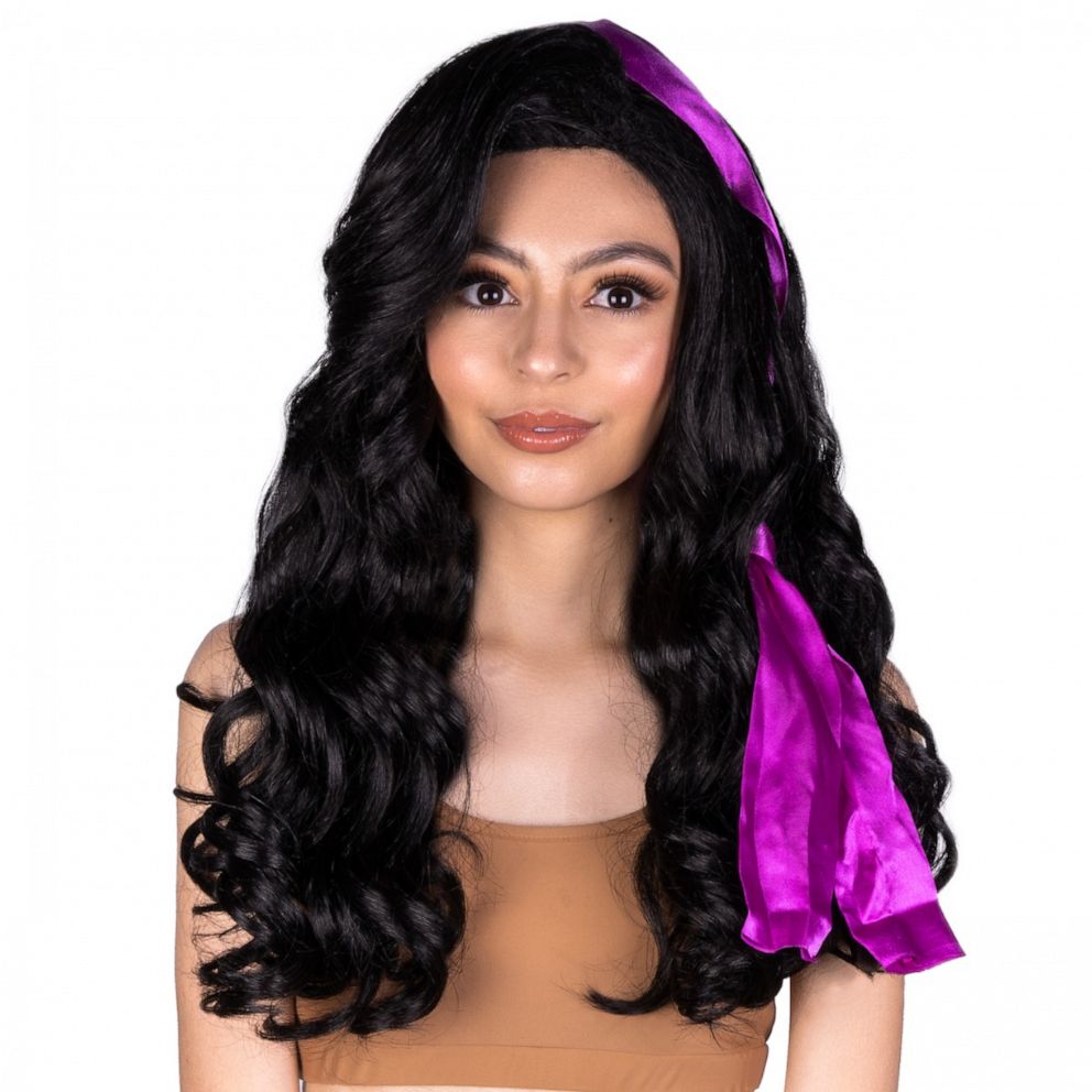 PHOTO: The "Esmeralda" wig is 20" long with big body waves and a pre-styled front with a dark purple head wrap. 
