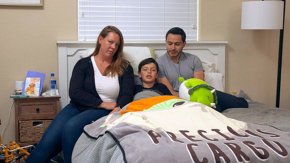 PHOTO: Dylan Armijo, 10, sits between his parents, Zach and Abby Armijo, while recovering at home from a shark attack.