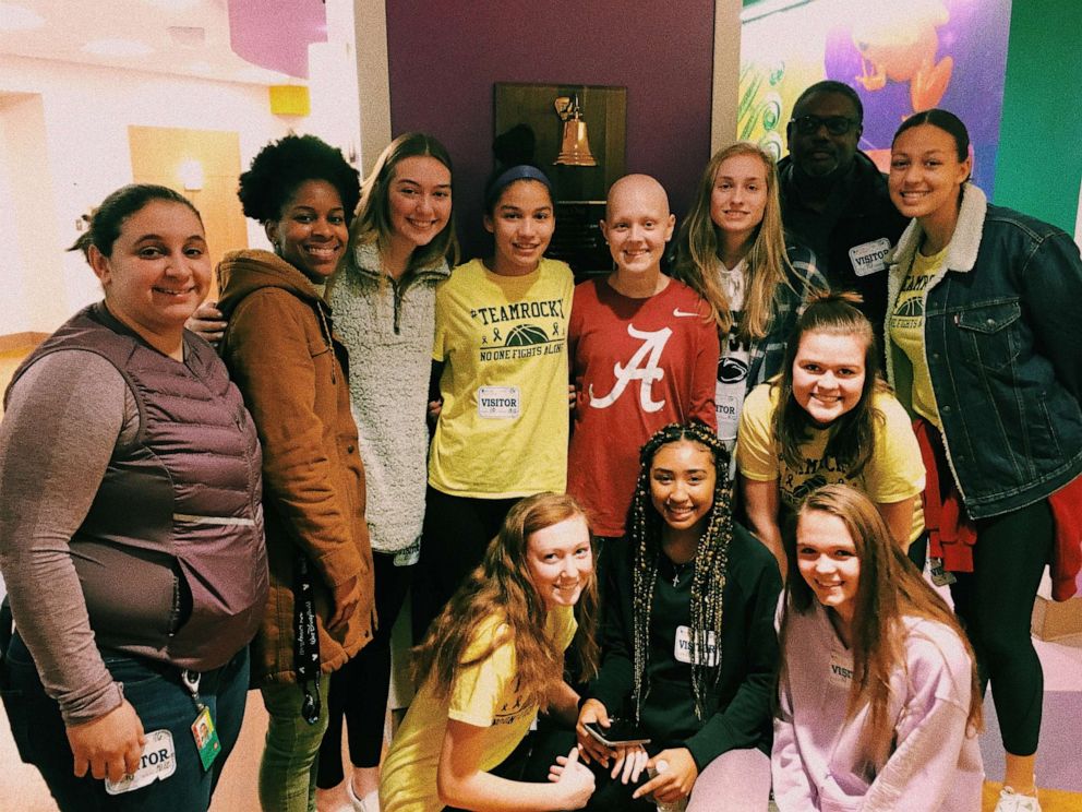 PHOTO: Assistant coach Ariel McKinney and Heritage High School girls varsity basketball teammates have supported Rocky through the years and visited her at the hospital.