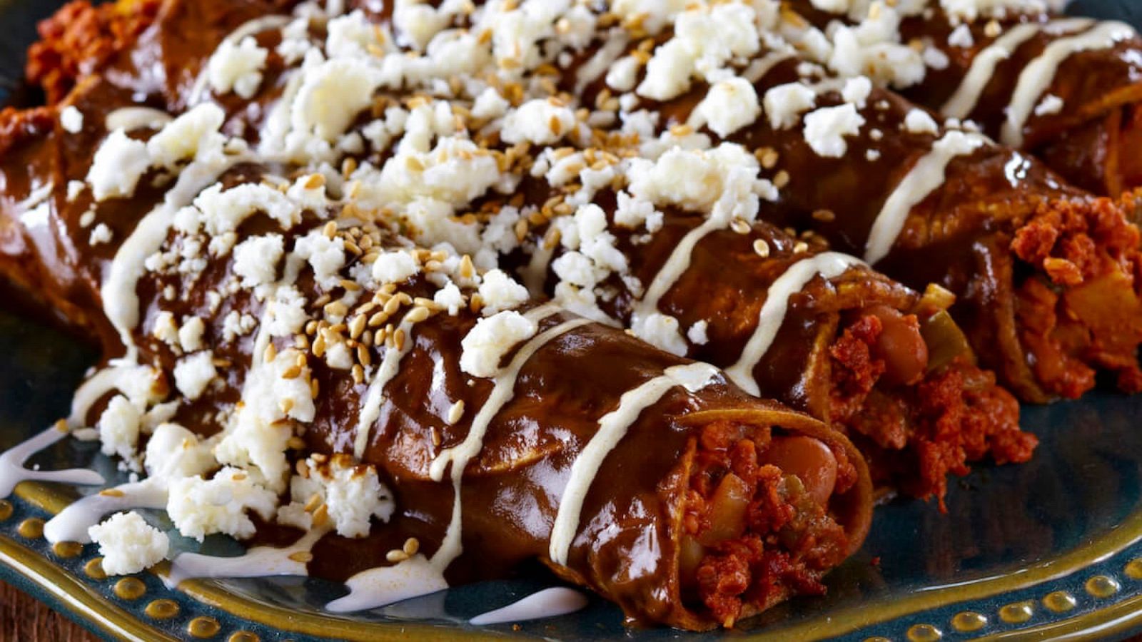 PHOTO: Enmoladas made with soy chorizo and topped with mole and Queso Fresco.