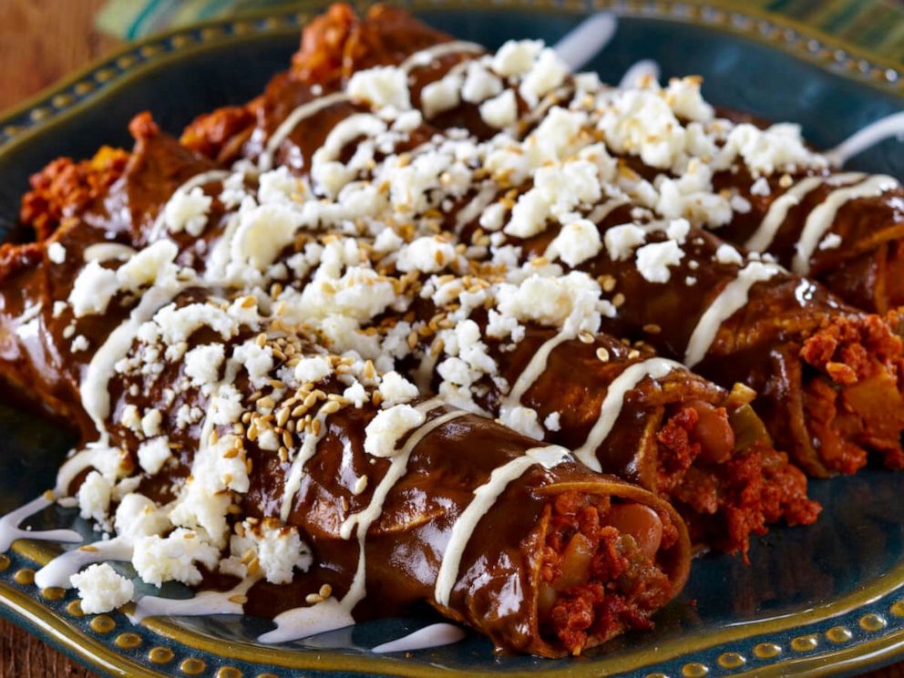 PHOTO: Enmoladas made with soy chorizo and topped with mole and Queso Fresco.