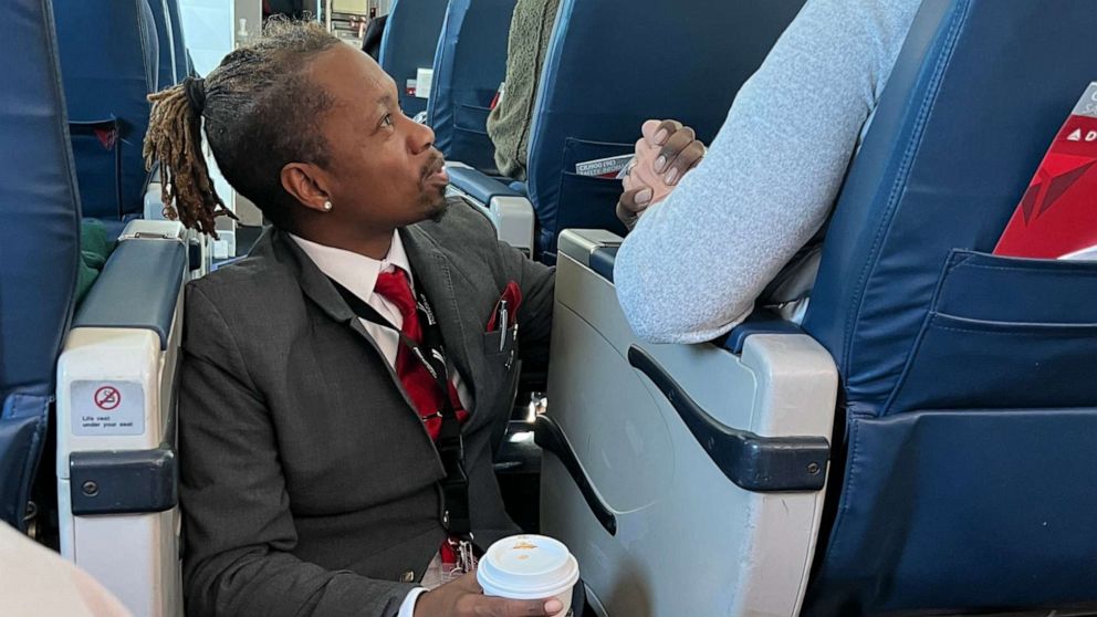 PHOTO: Floyd Dean-Shannon, 44, comforts a passenger during a Delta flight on Jan. 14.