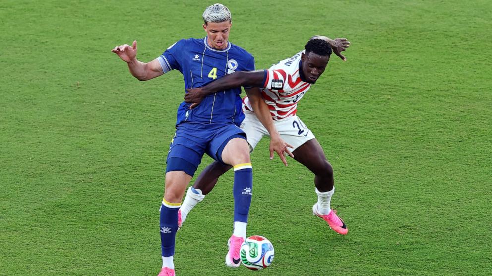 PHOTO: Folarin Balogun of the U.S. fouls Bosnia and Herzegovina's Tarik Muharemovic before being shown a red card during their FIFA World Cup 2026 Round of 32 match July 1, 2026 in Santa Clara, Calif.