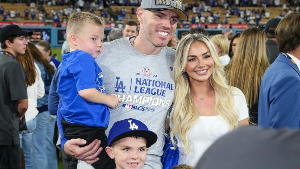 PHOTO: Freddie Freeman of the Los Angeles Dodgers poses for a photo with his family after defeating the New York Mets in Game 6 of the NLCS presented by loanDepot at Dodger Stadium in Los Angeles, Oct. 20, 2024.