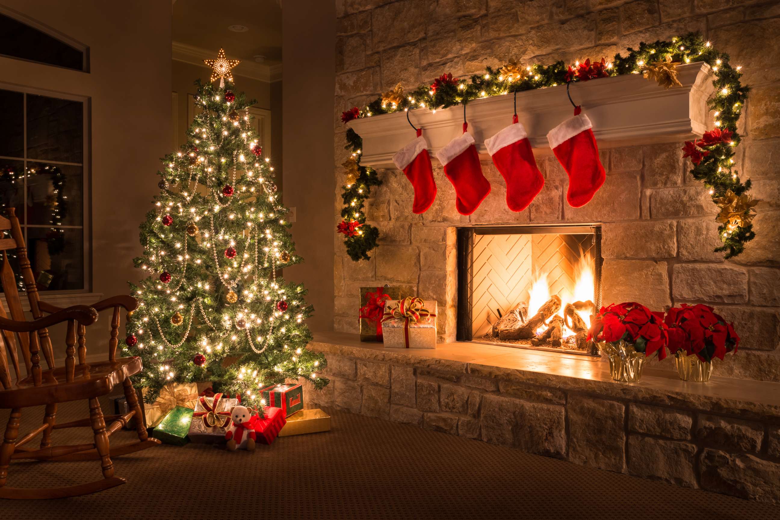PHOTO: A Christmas tree and stockings hang from the mantel of a fireplace are pictured in this undated stock photo.