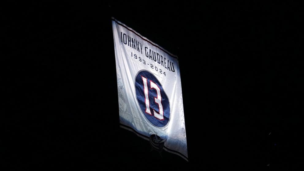 PHOTO: A banner honoring Columbus Blue Jackets player Johnny Gaudreau is raised to the rafters before a game against the Florida Panthers in the home opener at Nationwide Arena in Columbus, Ohio, Oct. 15, 2024.