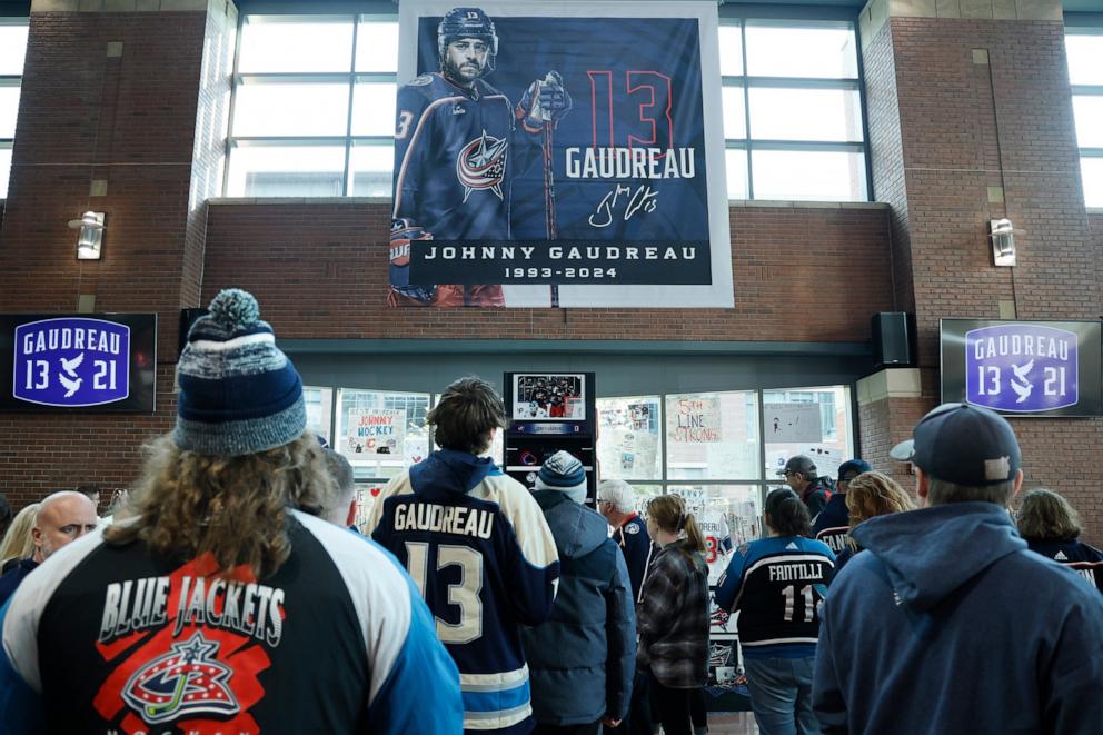 PHOTO: Fans look at a memorial of Columbus Blue Jackets' Johnny Gaudreau and his brother Matthew before the start of an NHL hockey game against the Florida Panthers in Columbus, Ohio, Oct. 15, 2024.