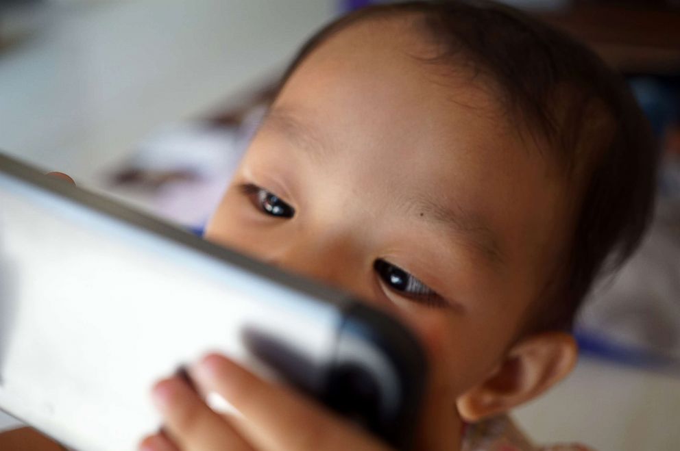 PHOTO: A baby plays with a smart phone in this undated stock photo.